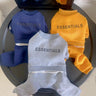 ESSENTIALS Logo Onesie